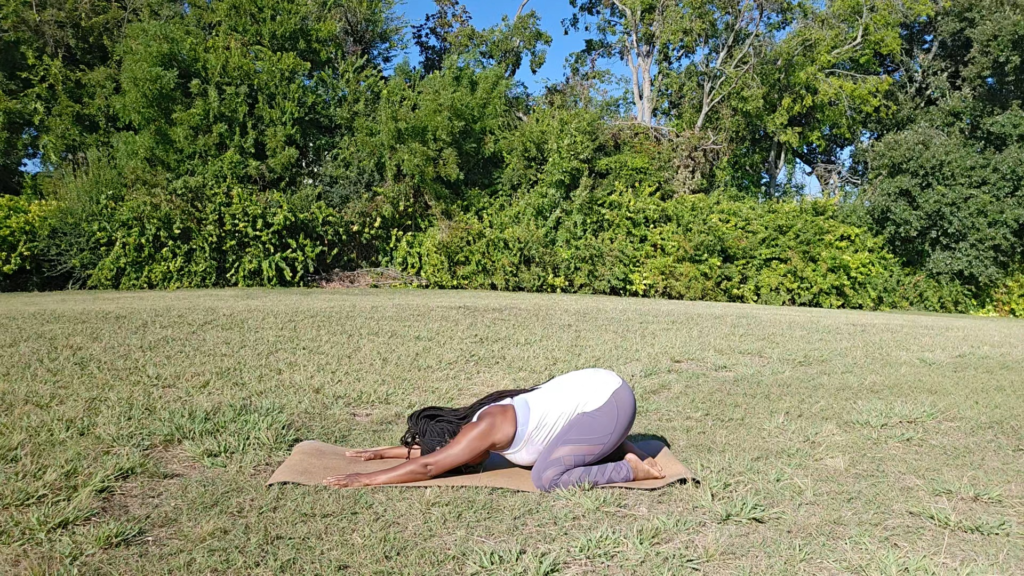 african american woman doing child's pose yoga for relaxation