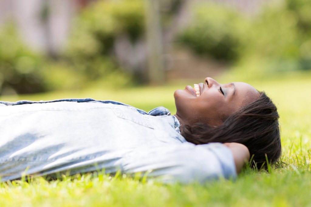 woman grounding and lying on grass