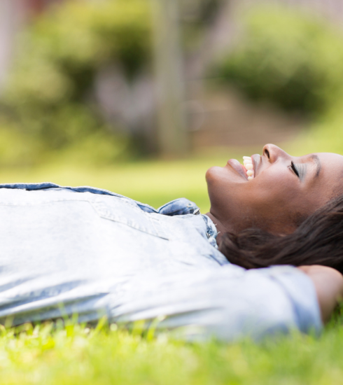 woman grounding and lying on grass