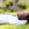 woman grounding and lying on grass