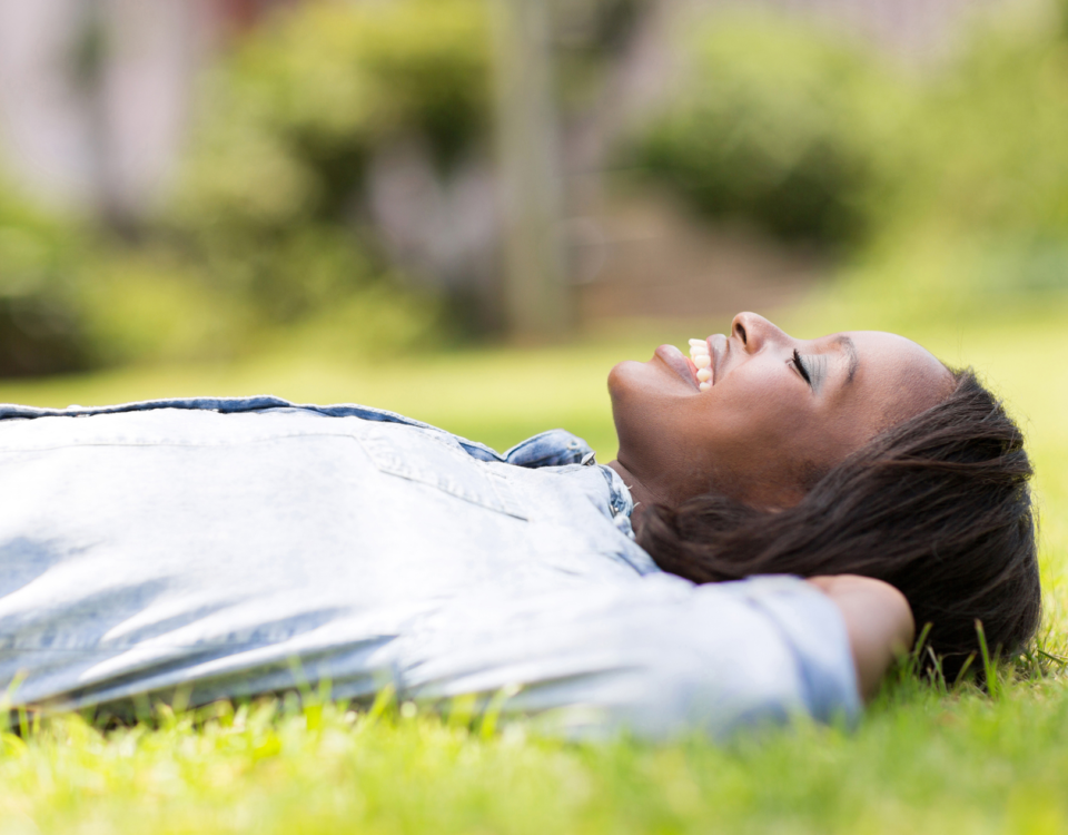 woman grounding and lying on grass